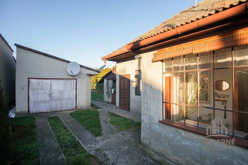 A family house on Pod kopcom Street in Nové Zámky with a garage and a satellite dish.