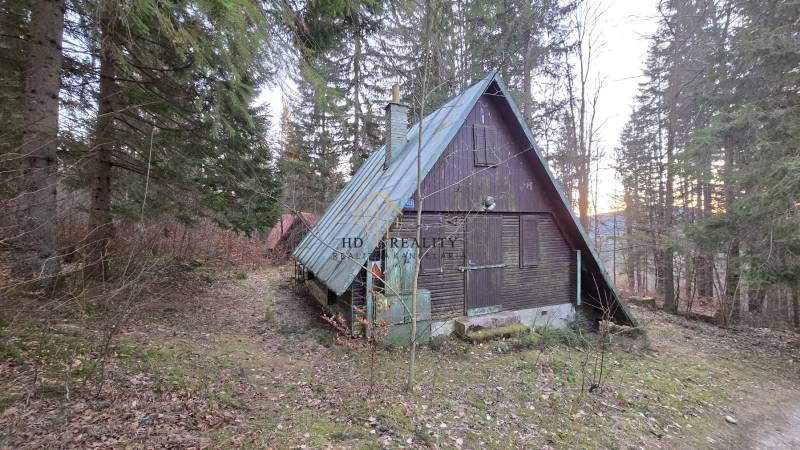 A cottage in the forest on Krpáčovo street in Krpáčovo with a sloped metal roof.