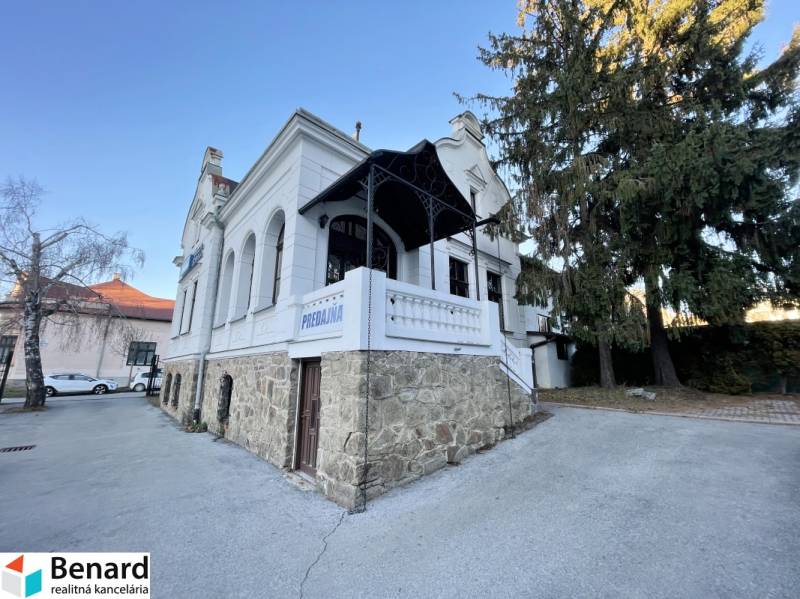 The building on Vajanského Street in Prešov with an elegant stone base and a white facade.