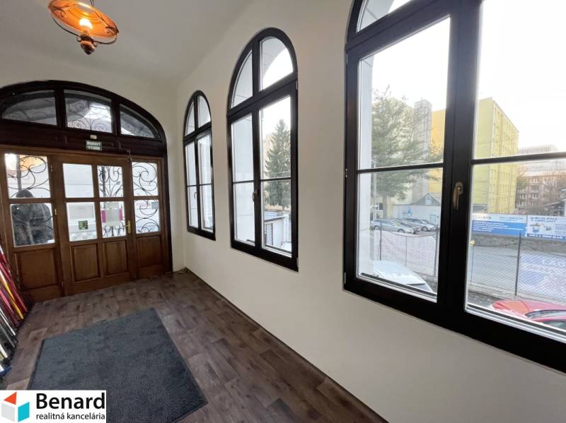 A building with a wooden decor floor and large windows on Vajanského Street in Prešov.