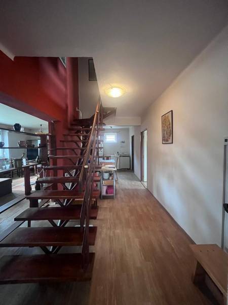 Interior of a family house with wooden stairs and a floor with a wooden decor.