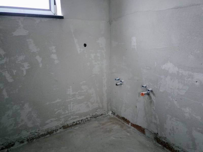 Plastered wall and preparation for installations in a family house.