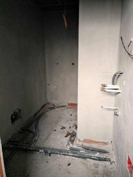 The interior of a family house during renovation with visible wiring and unfinished walls.