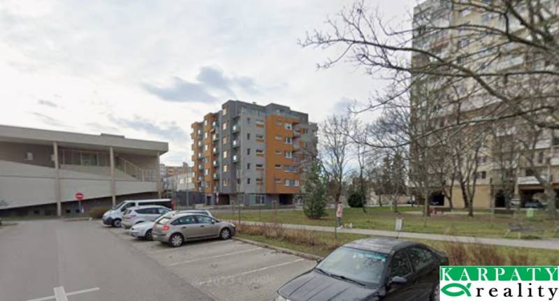 Terézia Vansová Street in Trnava with commercial spaces and parking.