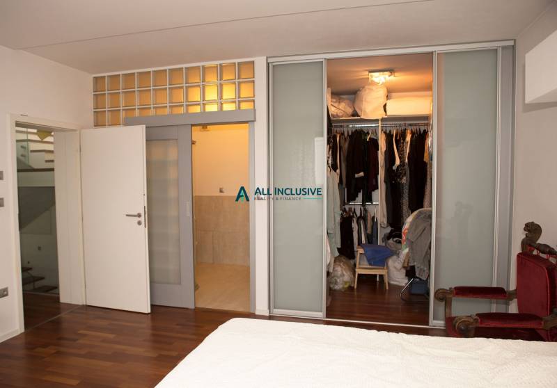 Bedroom in a family house with sliding doors and a wardrobe, floor with wood decor.