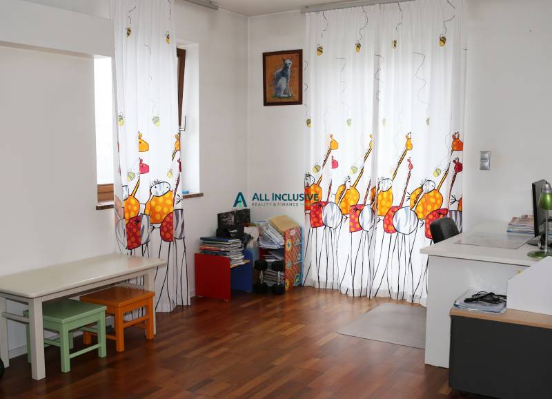 Children's room in a family house with colorful curtains and a wooden decor floor.