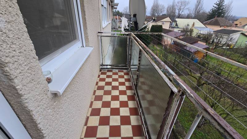 A balcony with a checkered floor overlooking the gardens on Sadová Street in Piešťany.