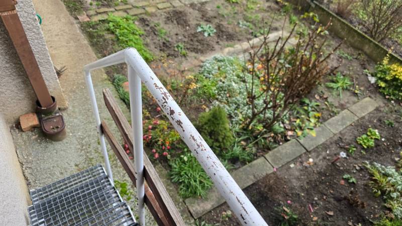 A garden with flowers and a metal railing on Sadová Street in Piešťany.