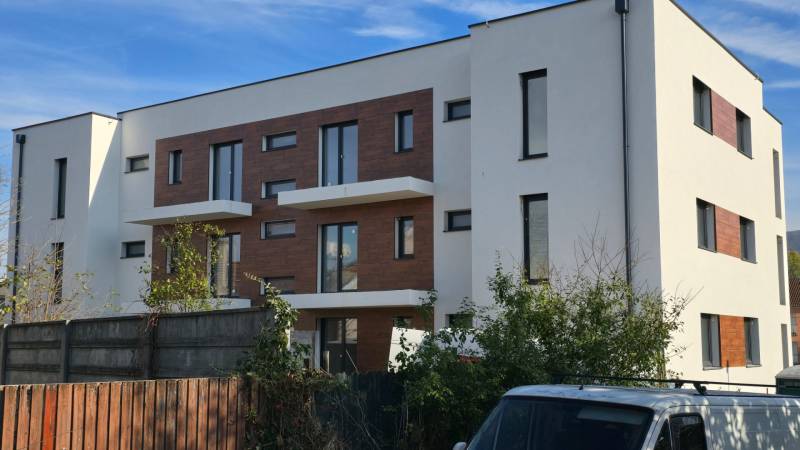A white three-story building with wooden facade decorations on Banka Street in Piešťany.