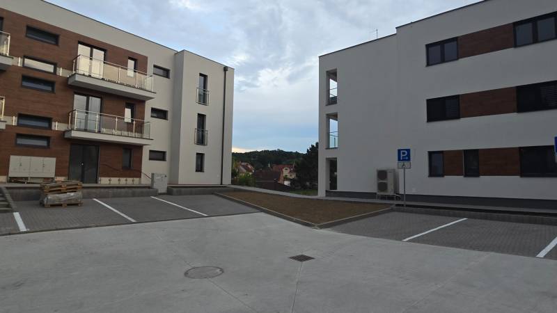 New buildings near Banka Street in the town of Piešťany with a parking lot and balconies.