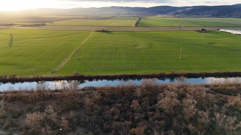 A view of the green fields, river, and forests around Nová Ves nad Váhom.