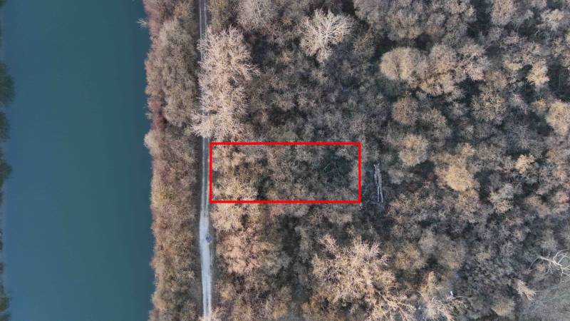 Aerial view of recreational grounds in Nová Ves nad Váhom, surrounded by forest and river.