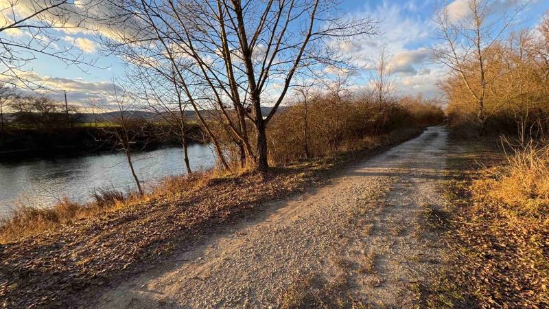 Recreational plots in Nová Ves nad Váhom with a natural road and river in autumn.