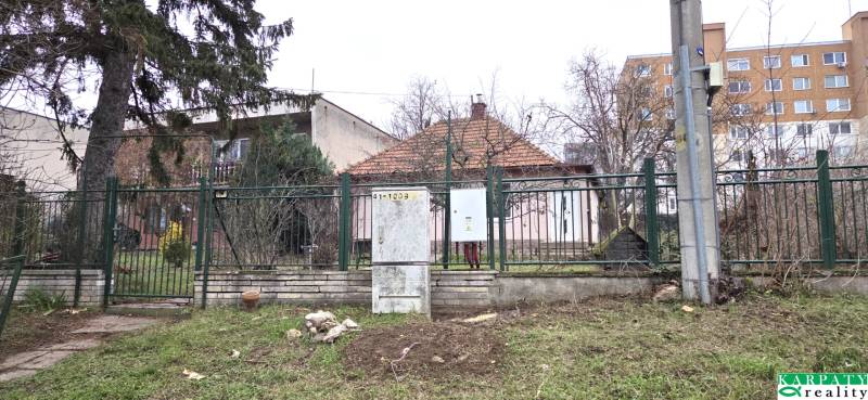 A family house on 29th August Street in Levice, surrounded by a garden and a fence.