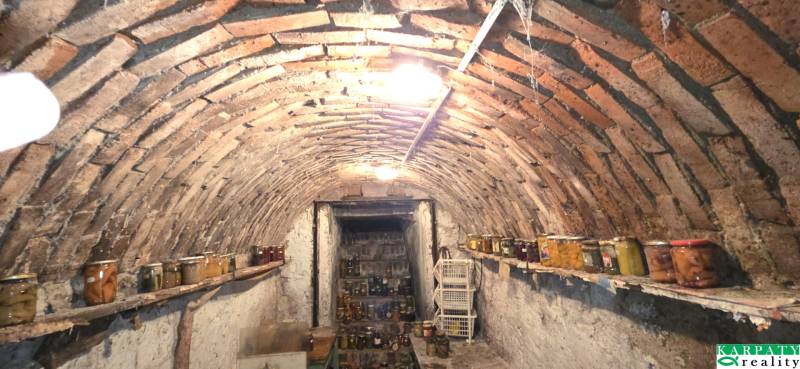A cellar with a brick vault in a family house, full of canning jars.