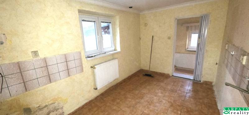 Room in a family house with tiles on the wall and floor tiles.