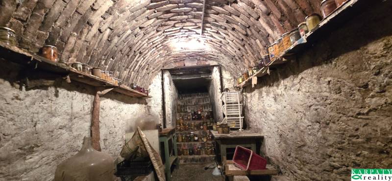 A traditional cellar in a family house, full of preserves and antique furniture.