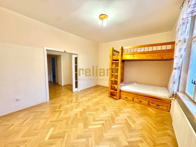 A room in a 4-room apartment with a bunk bed and a floor with a wooden decor.