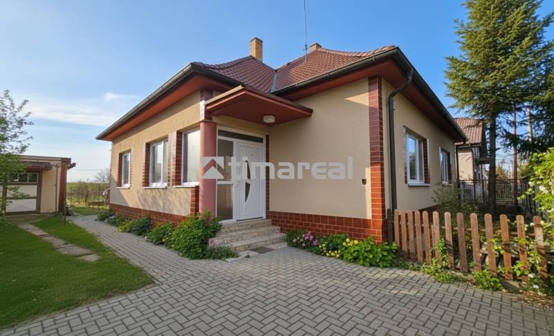 A family house in Križovany nad Dudváhom with a landscaped garden and a paved walkway.