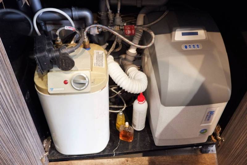 Water treatment technology in commercial spaces, including pipes and maintenance bottles.