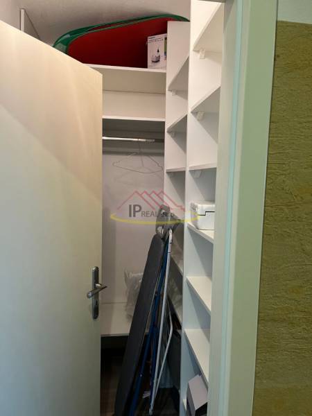 Storage space with a wardrobe and shelves in a 4-room apartment.
