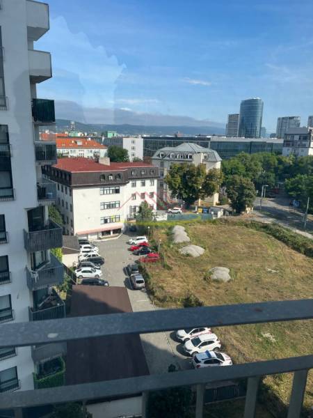 View of the surroundings from the apartment on Jégého, Bratislava - Nivy, parking lot, buildings.