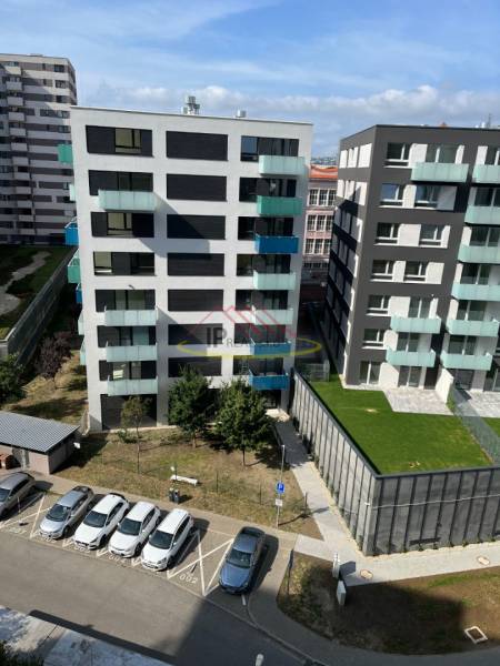 View of modern apartment buildings with parked cars on Jégého Street, Bratislava - Nivy.
