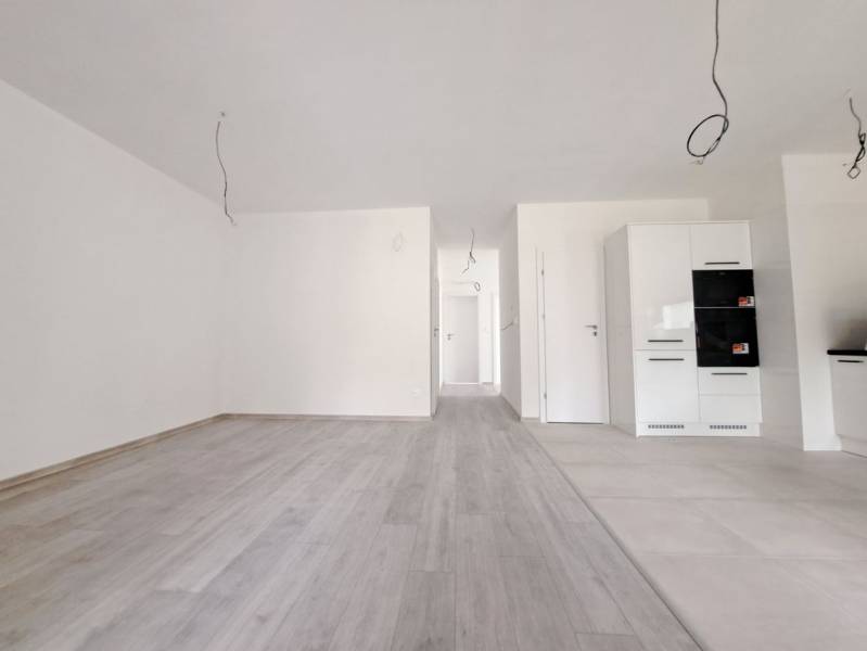 The interior of a family house with white walls and a floor with a wood decor.