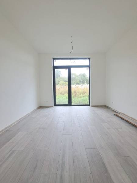 Interior of a family house with a wooden decor floor and a large window.