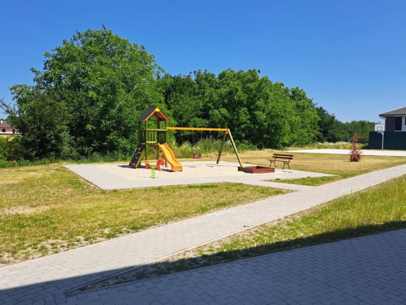 A playground with climbing frames and swings in Galanta surrounded by greenery and pathways.
