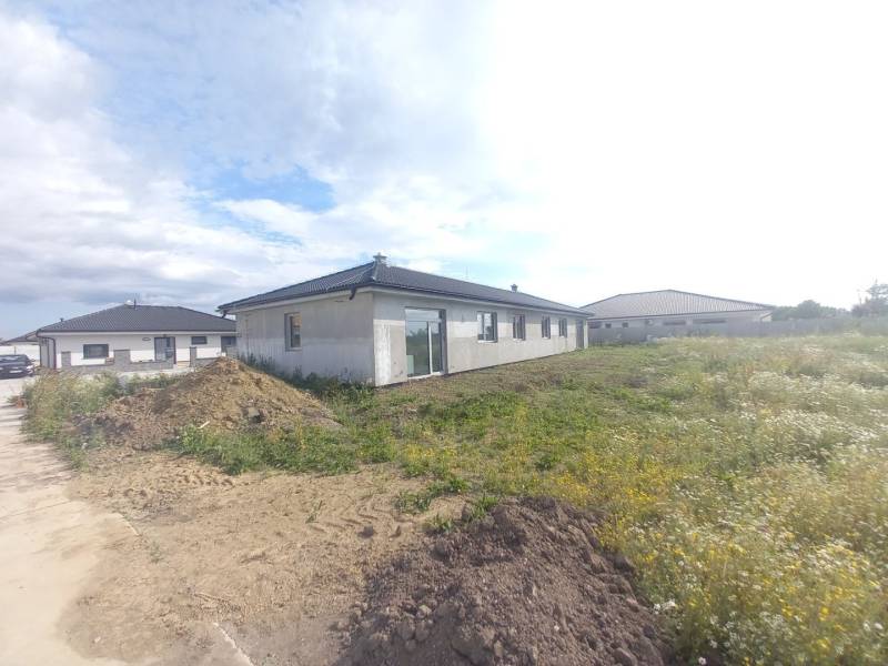 A family house in Galanta surrounded by adjacent land and other houses.