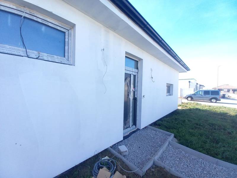Family house in Galanta, with a white facade and paving stones in the front garden.