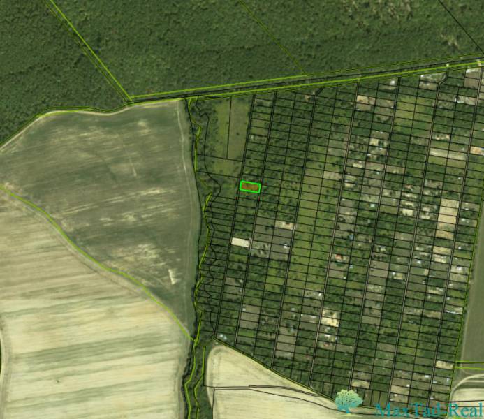 Aerial view of gardens in Šaca, Košice, surrounded by fields and forest.