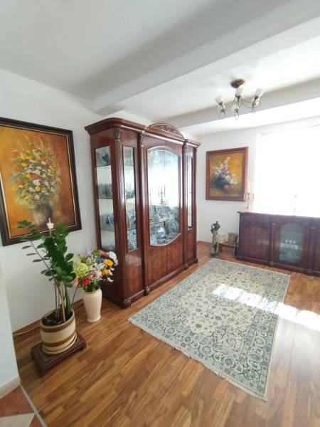 Living room in a family house with a carpet, cabinet, and floor with a wooden decor.