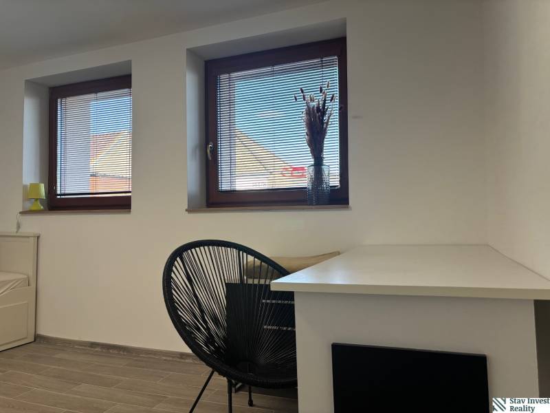 Wall with windows, window sills, table and chair, family house, floor with wooden decor.