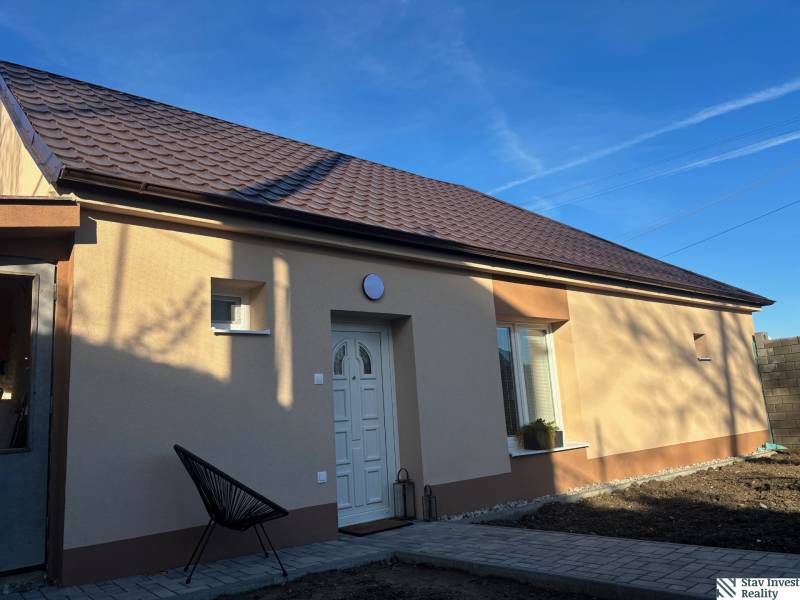 A family house in Blatné with a brown roof and a light facade.