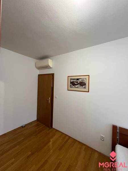 A room with a wooden floor decor, air conditioning, and a painting, 3-room apartment.