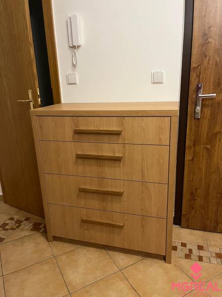 Hallway in a 3-room apartment with a cabinet and tiles.