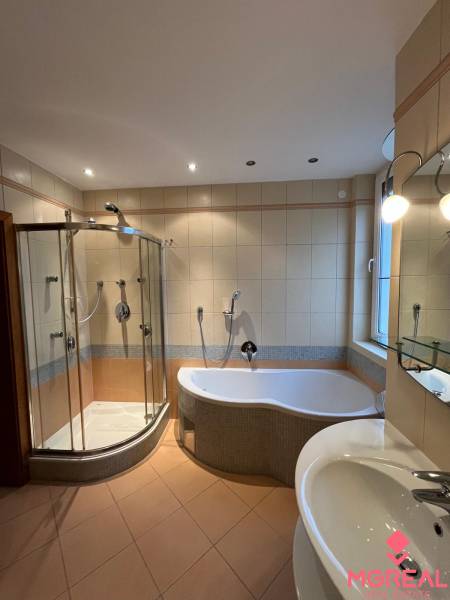 A bathroom in a 3-room apartment with a bathtub, a shower, and a sink.