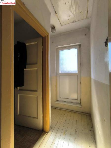 A hallway in a family house with a bright entrance and wooden flooring.