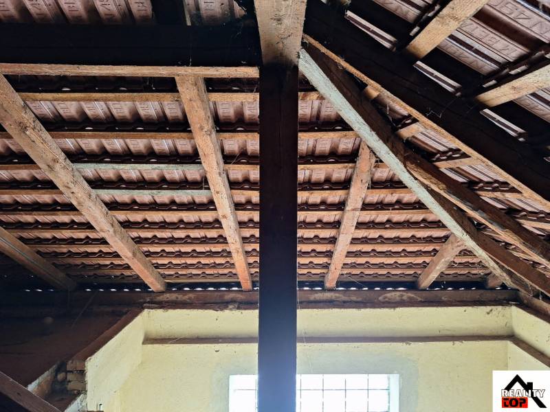 Roof structure with tiles and wooden beams in a family house.