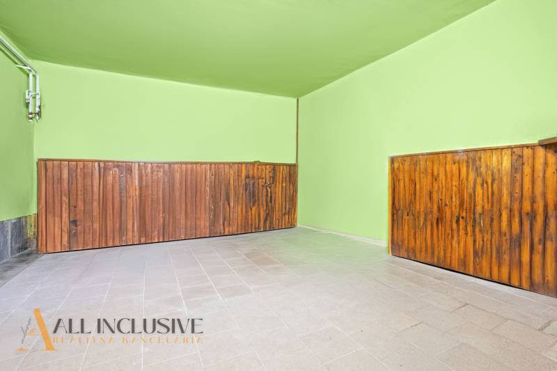 Green walls and wooden paneling in the interior of a family house.
