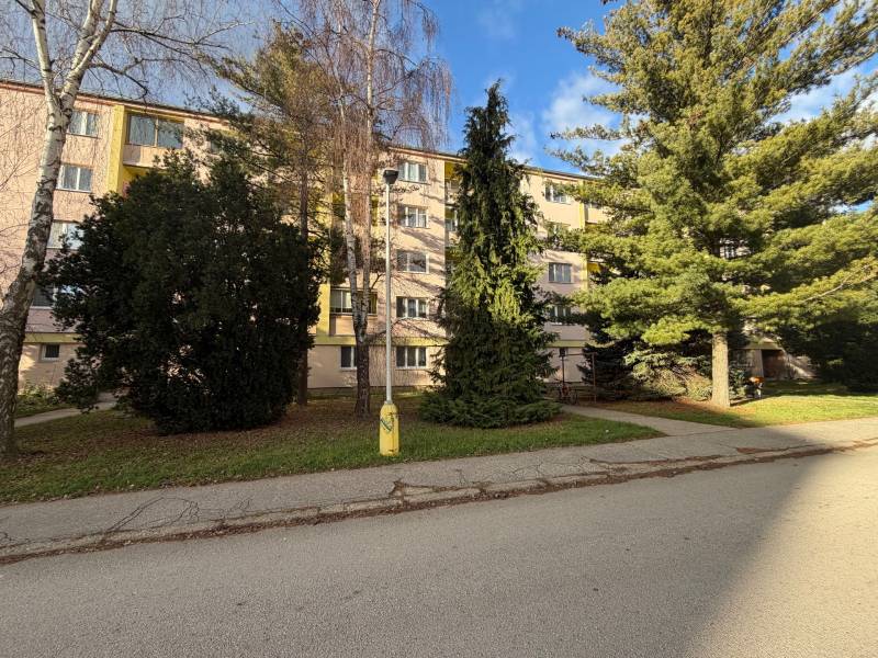An apartment building surrounded by trees on Kalinčiakova Street in Senica.