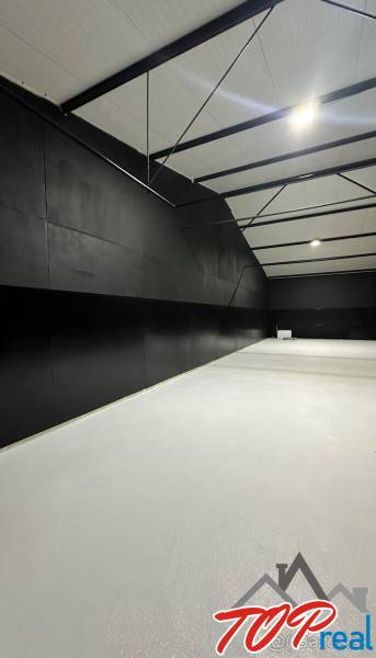 The interior of garages with black walls and a light floor in Sady nad Torysou.