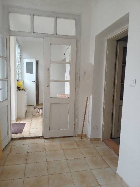 Interior of a family house with white doors and tiled floor.