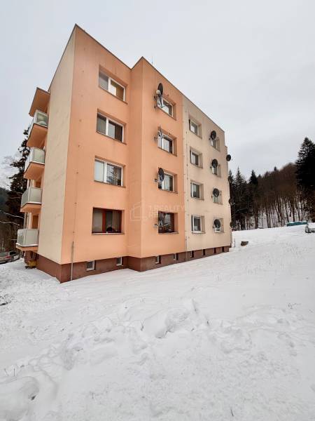 An apartment building in the snowy environment of Oščadnica offers affordable living in 2-bedroom apartments.