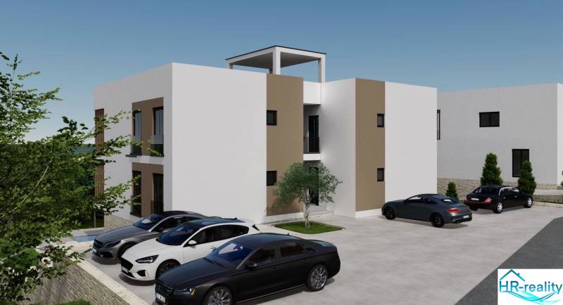 Recreational apartment in Ciovo with parked cars and surrounding greenery.