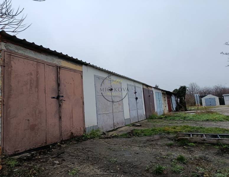 Garages on Fabrická Street in Nitra, surrounded by grass and concrete surfaces.