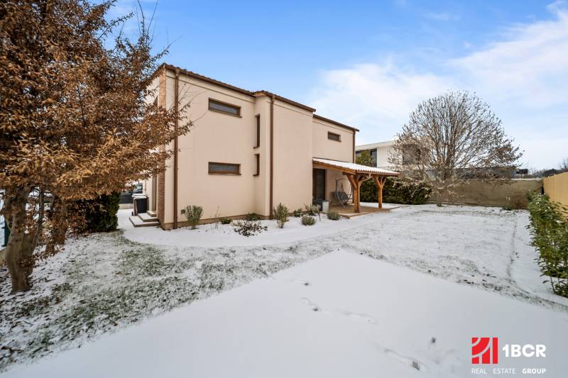 A family house on Konopiská Street in Bratislava - Čunovo with a snow-covered garden.