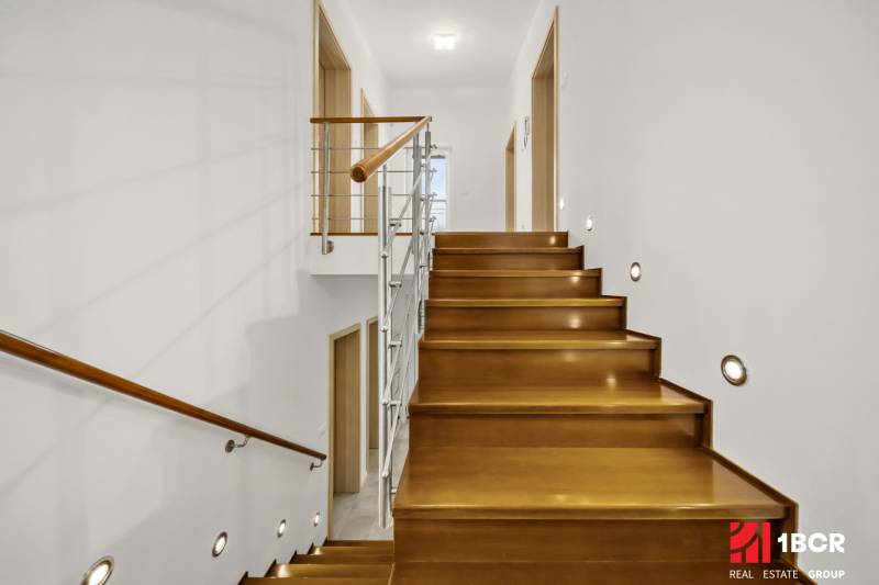 A staircase with a wooden decor and railing in a family house.